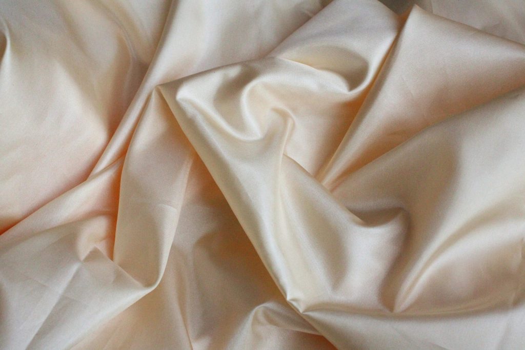 white textile on brown wooden table